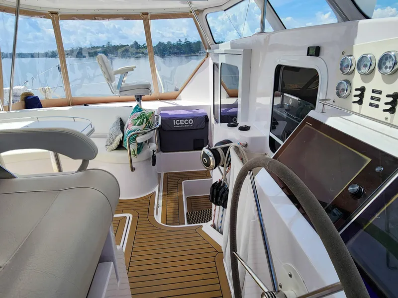 Slide: The Image of Luxurious 2014 Antares 44i yacht interior with steering wheel, gauges, and scenic water view. - 45