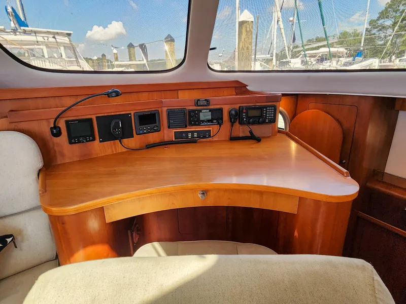 Slide: The Image of Navigation station inside 2014 Antares 44i yacht with control panels and wooden desk. - 5