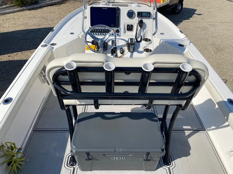 Slide: The Image of 2020 Key West 230 Bay Reef boat interior with console, steering wheel, and rod holders. - 12