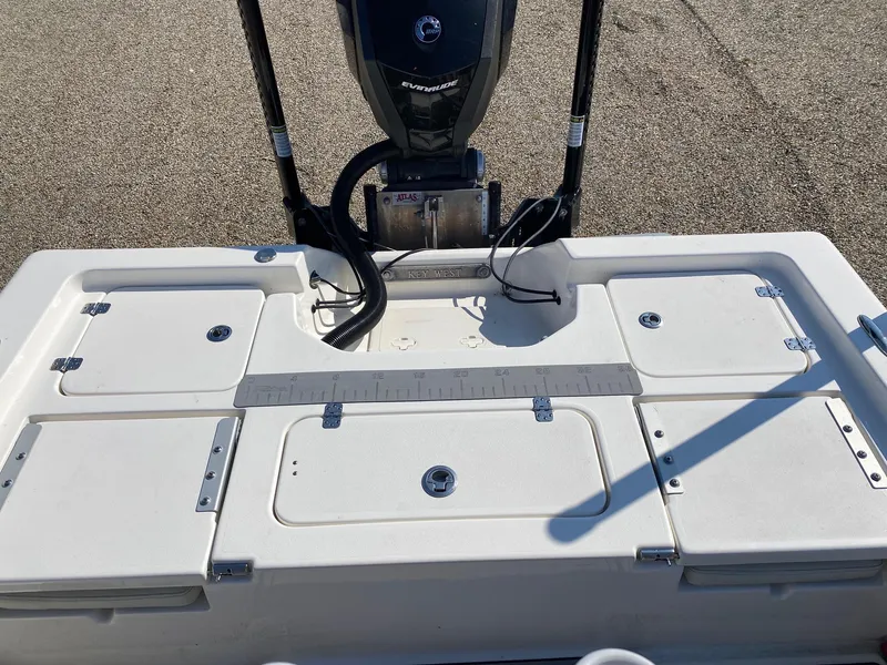 Slide: The Image of 2020 Key West 230 Bay Reef boat deck with storage compartments and motor. - 13