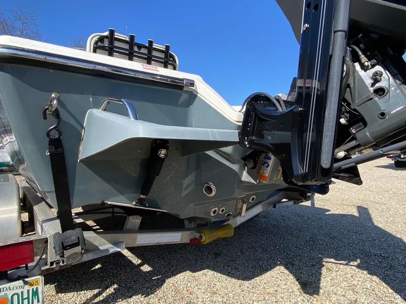 Slide: The Image of 2020 Key West 230 Bay Reef boat on trailer, showing motor and hull details. - 6