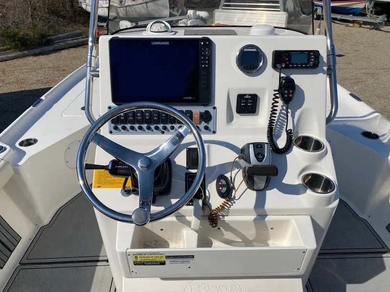 Slide: The Image of 2020 Key West 230 Bay Reef boat console with steering wheel and navigation equipment. - 8
