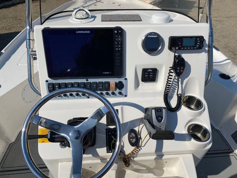 Slide: The Image of 2020 Key West 230 Bay Reef boat console with steering wheel and navigation equipment. - 9