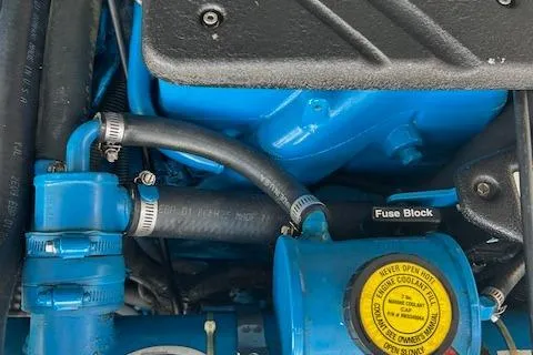 Slide: The Image of Engine components of a 2004 Tiara Yachts 2900 Coronet, featuring hoses and a fuse block. - 13