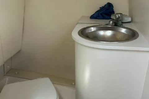 Slide: The Image of Compact bathroom in 2004 Tiara Yachts 2900 Coronet with sink and toilet. - 4