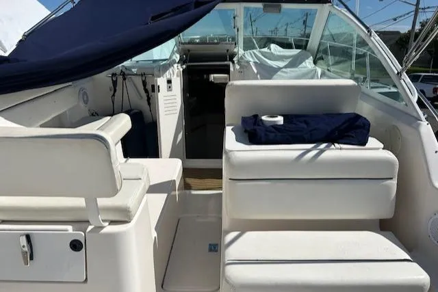 Slide: The Image of 2004 Tiara Yachts 2900 Coronet interior with white seating and blue cover. - 7