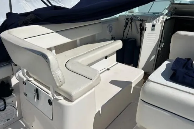 Slide: The Image of 2004 Tiara Yachts 2900 Coronet interior with white seating and helm area. - 8