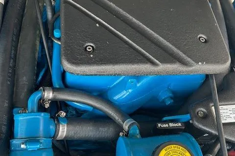 Slide: The Image of Engine compartment of a 2004 Tiara Yachts 2900 Coronet, featuring blue components and fuse block. - 9