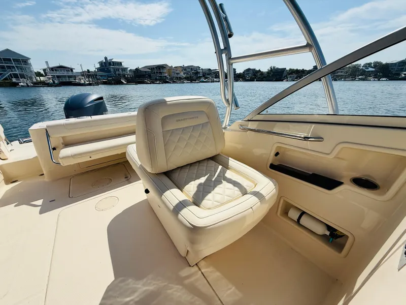 Slide: The Image of 2018 Grady-White Freedom 235 boat interior with seating, on a sunny day by the water. - 10