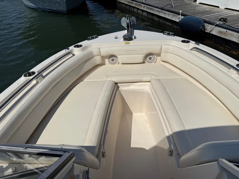 Slide: The Image of 2018 Grady-White Freedom 235 boat interior with cushioned seating at dock. - 11