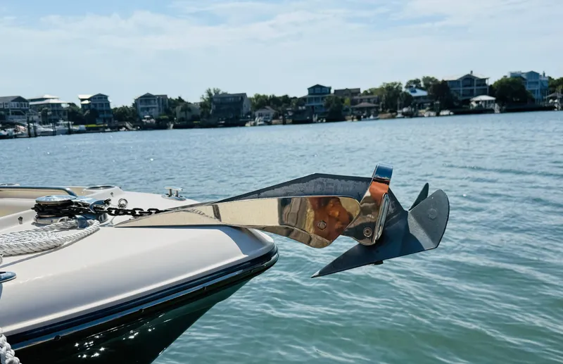 Slide: The Image of 2018 Grady-White Freedom 235 boat with anchor, docked near waterfront homes. - 12