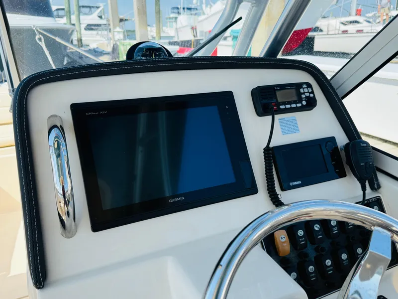 Slide: The Image of Control panel of a 2018 Grady-White Freedom 235 boat with navigation equipment. - 14