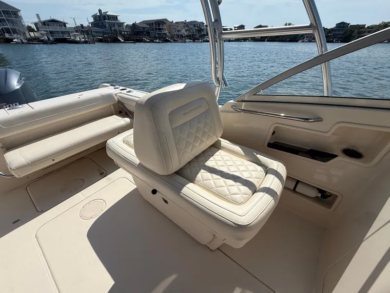 Slide: The Image of 2018 Grady-White Freedom 235 boat interior with luxurious seating by the water. - 16