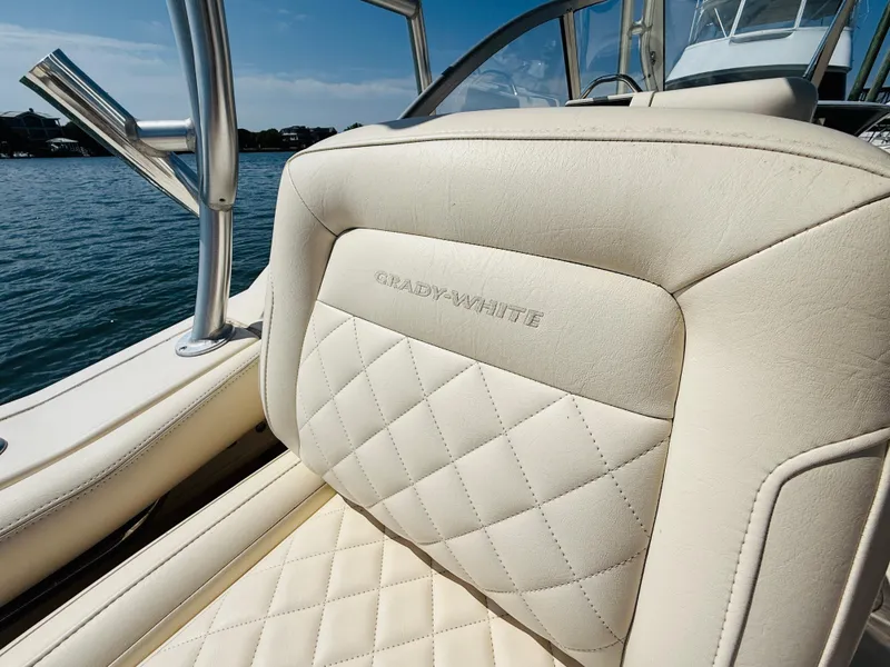 Slide: The Image of 2018 Grady-White Freedom 235 boat seat with quilted design, near water. - 18