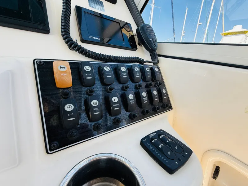 Slide: The Image of Control panel of 2018 Grady-White Freedom 235 boat with switches and navigation equipment. - 20