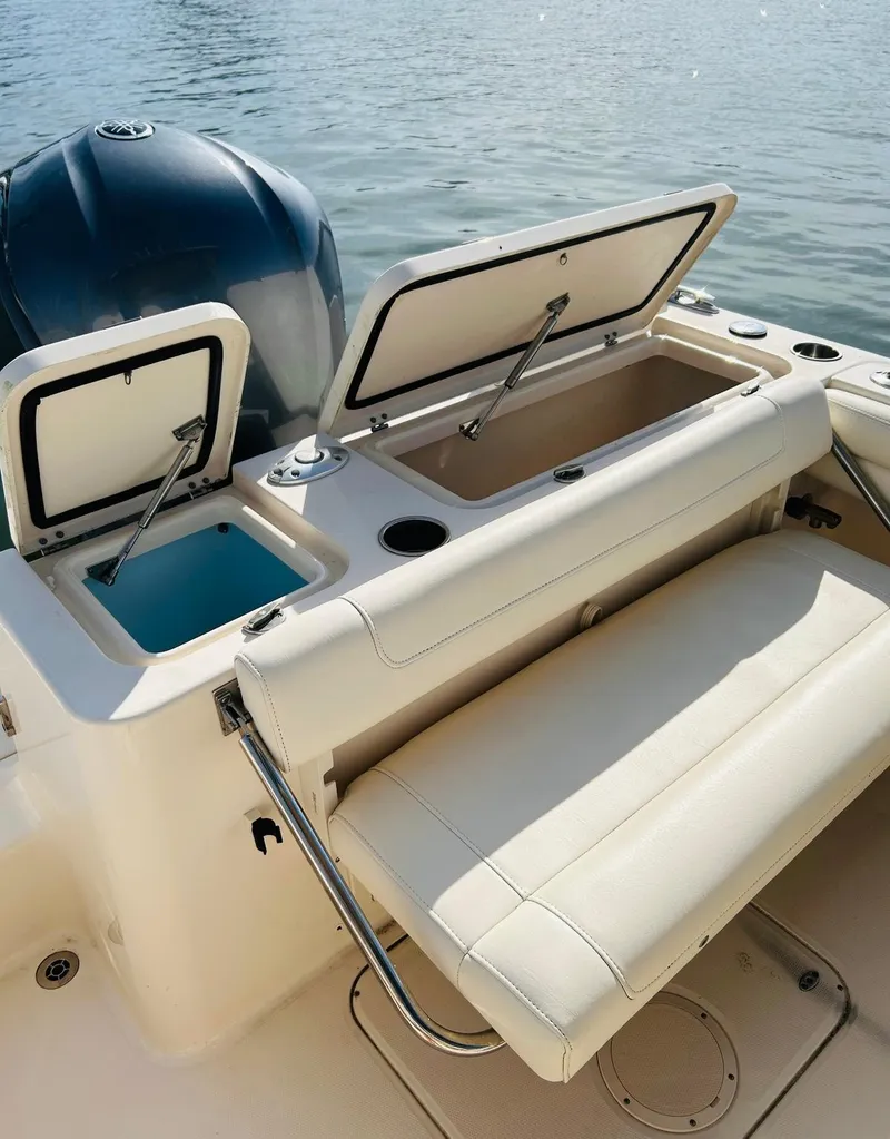 Slide: The Image of 2018 Grady-White Freedom 235 boat with open storage compartments on a sunny day. - 23