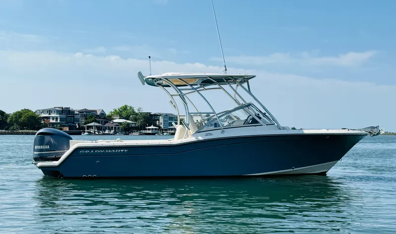 Slide: The Image of 2018 Grady-White Freedom 235 boat on calm water, clear sky background. - 4
