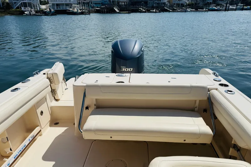 Slide: The Image of 2018 Grady-White Freedom 235 boat interior with Yamaha 300 engine on calm water. - 7