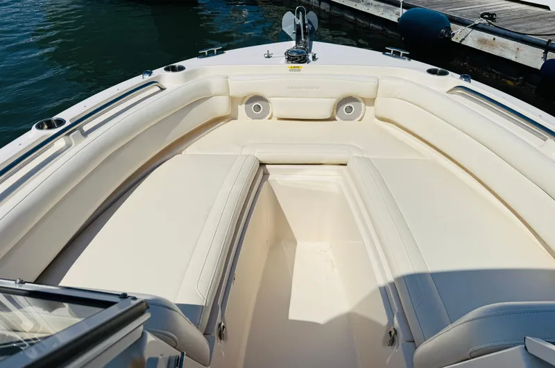 Slide: The Image of 2018 Grady-White Freedom 235 boat interior with spacious seating and speakers. - 8