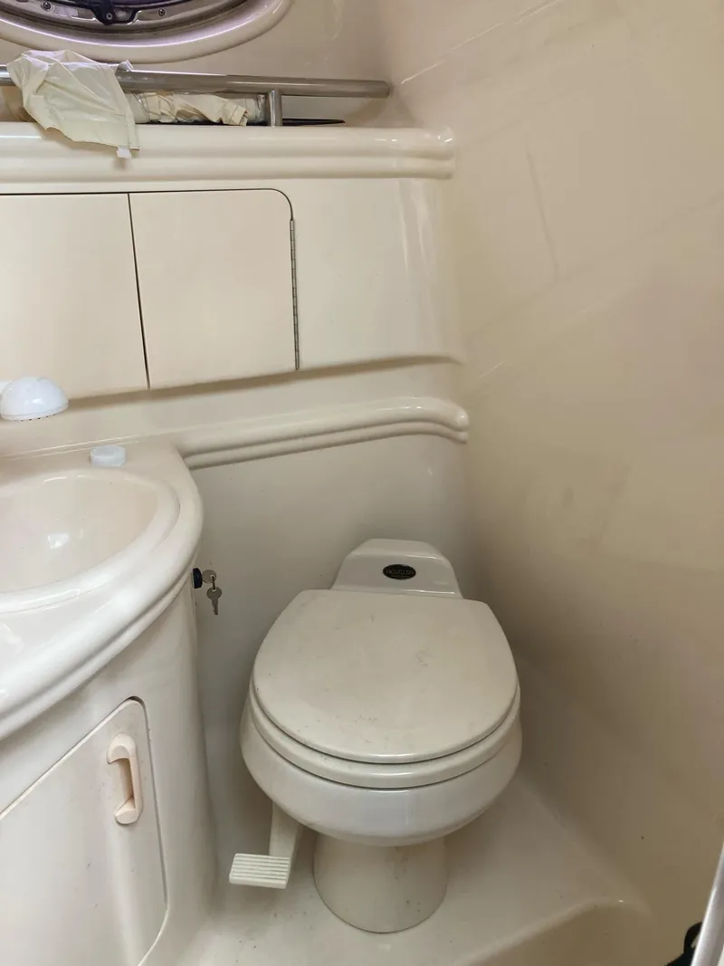 Slide: The Image of 2003 Sea Ray 280 Sundancer bathroom with toilet and sink. - 11
