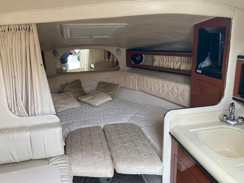 Slide: The Image of Interior of 2003 Sea Ray 280 Sundancer boat with cozy cabin and kitchenette. - 2
