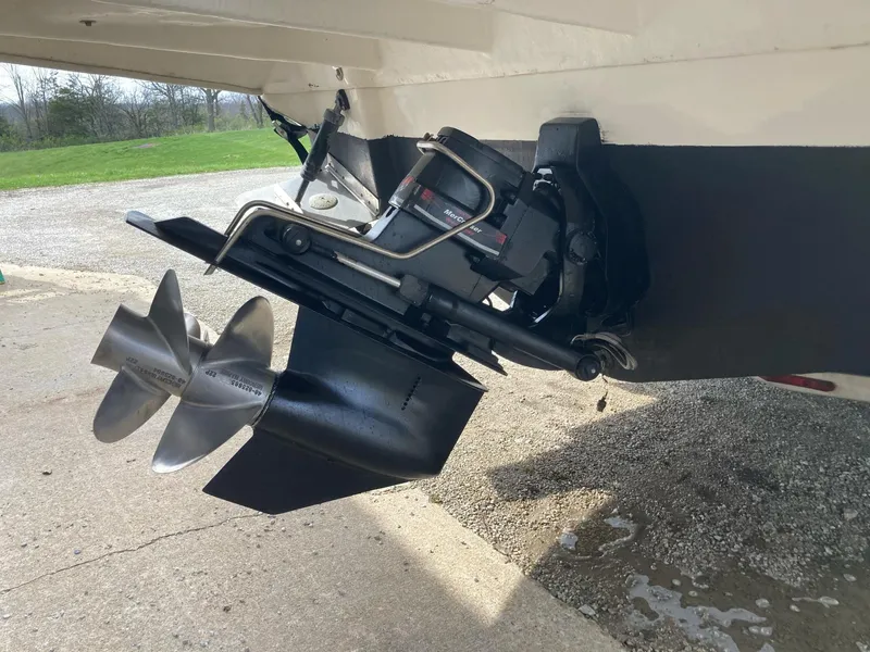 Slide: The Image of 2003 Sea Ray 280 Sundancer boat propeller and stern drive on a concrete surface. - 3