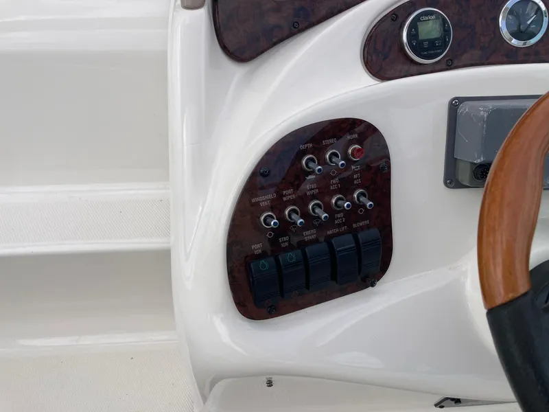 Slide: The Image of Control panel of a 2003 Sea Ray 280 Sundancer boat with switches and gauges. - 4