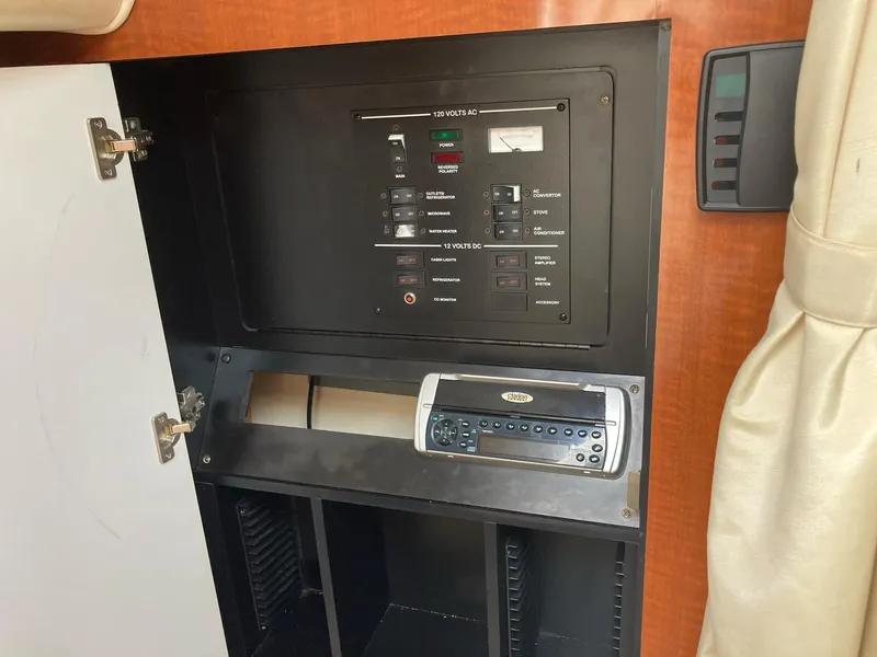 Slide: The Image of 2003 Sea Ray 280 Sundancer electrical panel and control system inside cabin. - 8