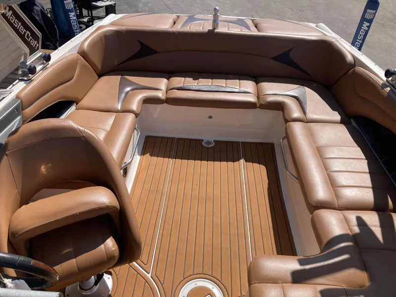 Slide: The Image of 2008 MasterCraft MariStar 215 boat interior with brown leather seating and wooden flooring. - 12