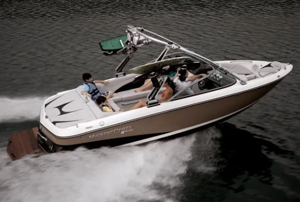 Slide: The Image of 2008 MasterCraft MariStar 215 boat cruising on water with passengers onboard. - 13