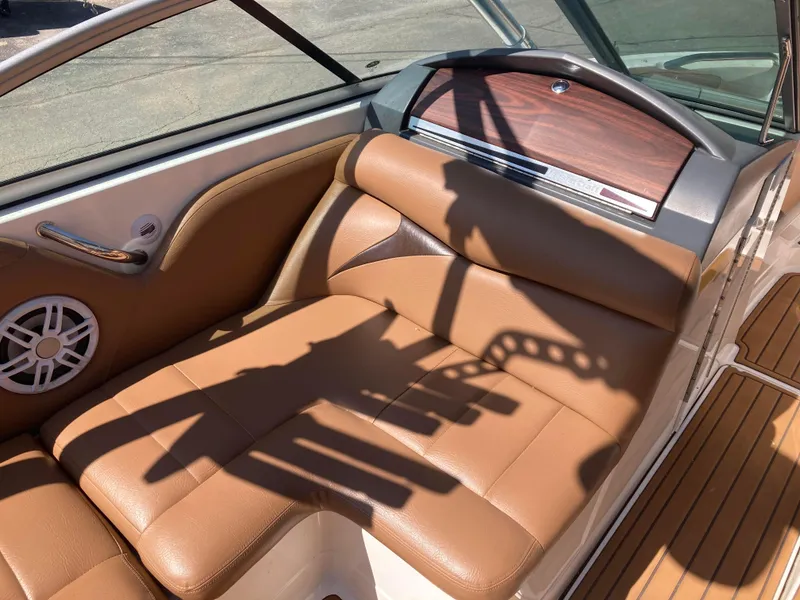 Slide: The Image of 2008 MasterCraft MariStar 215 interior with tan leather seating and wood accents. - 14