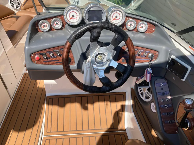 Slide: The Image of 2008 MasterCraft MariStar 215 dashboard with wood accents and modern controls. - 15