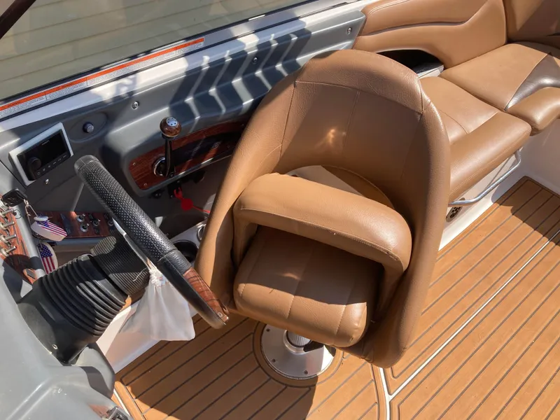Slide: The Image of 2008 MasterCraft MariStar 215 boat interior with tan leather seating and wood accents. - 16