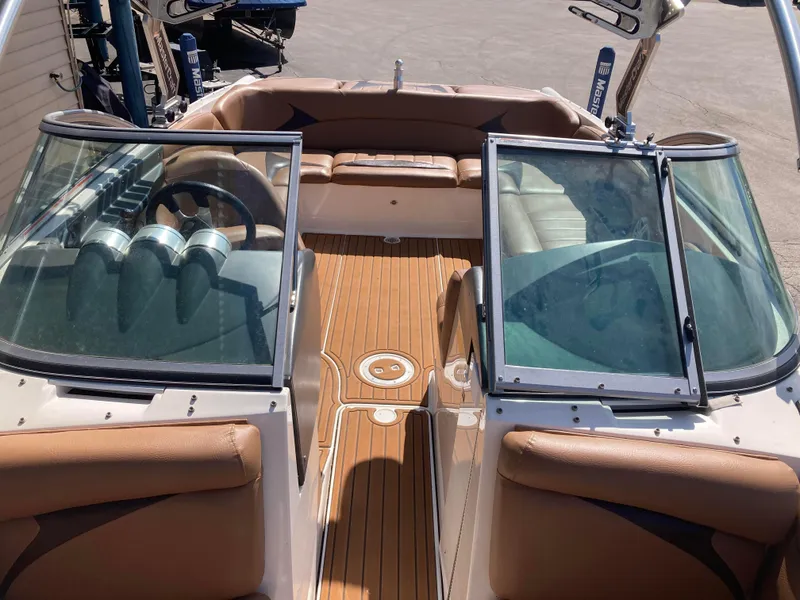 Slide: The Image of 2008 MasterCraft MariStar 215 boat interior with tan seating and wooden flooring. - 17