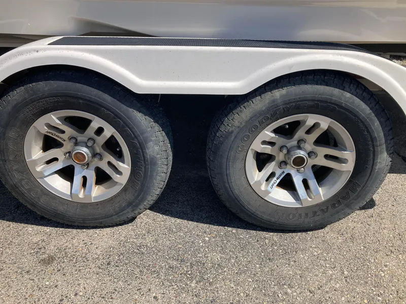 Slide: The Image of Trailer wheels of a 2008 MasterCraft MariStar 215 boat on pavement. - 19