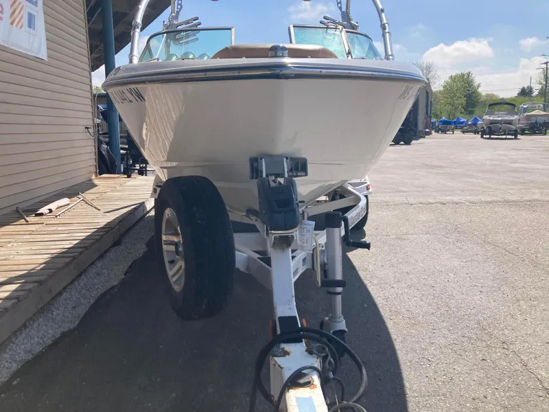 Slide: The Image of 2008 MasterCraft MariStar 215 boat on trailer, parked outdoors under sunny sky. - 4