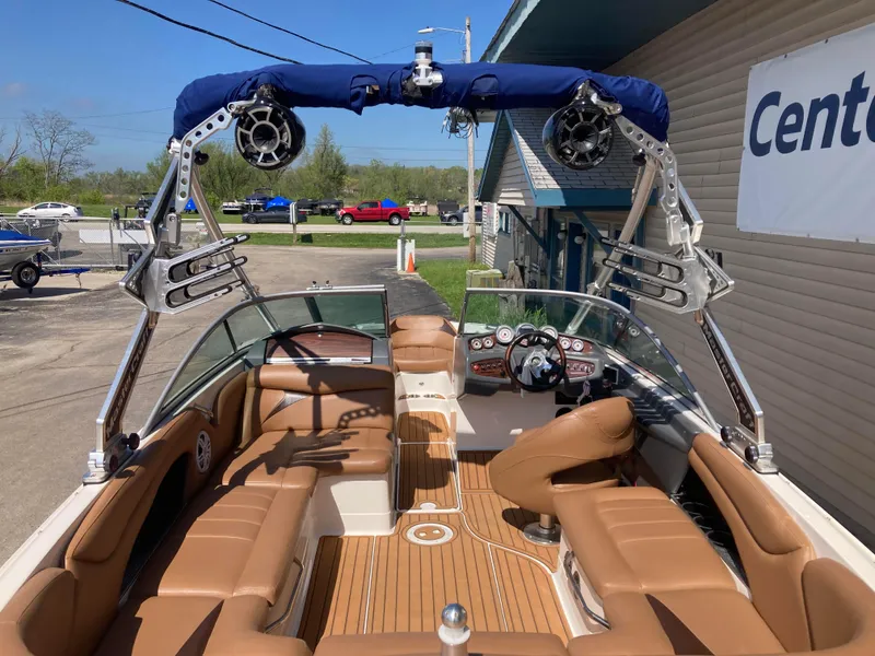 Slide: The Image of 2008 MasterCraft MariStar 215 boat interior with tan seating and advanced audio system. - 7