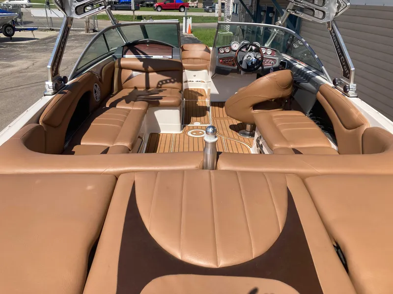 Slide: The Image of 2008 MasterCraft MariStar 215 boat interior with tan leather seating and sleek dashboard. - 8
