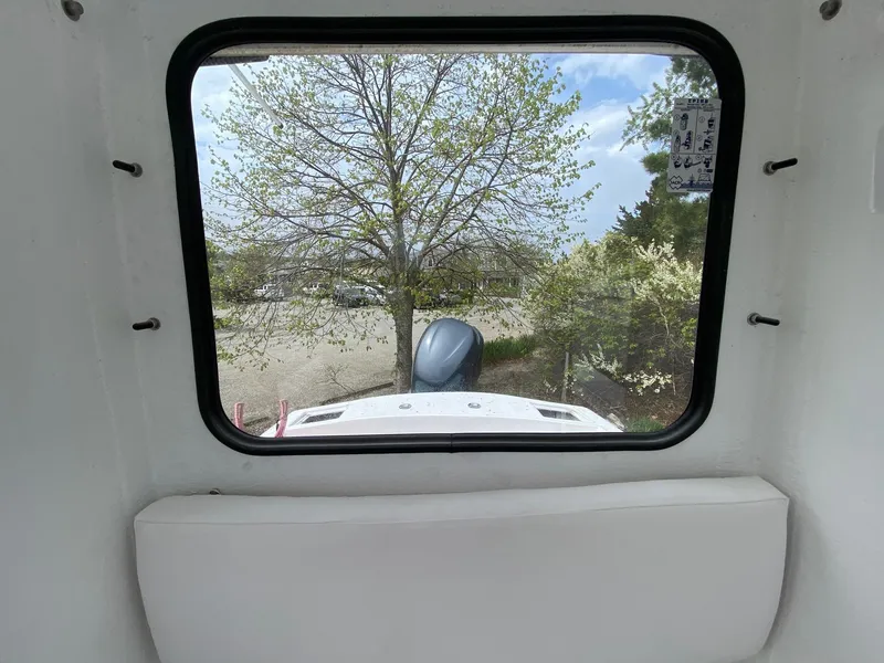 Slide: The Image of View from inside a 1987 SeaCraft 23 CC boat, looking out at trees and sky. - 12