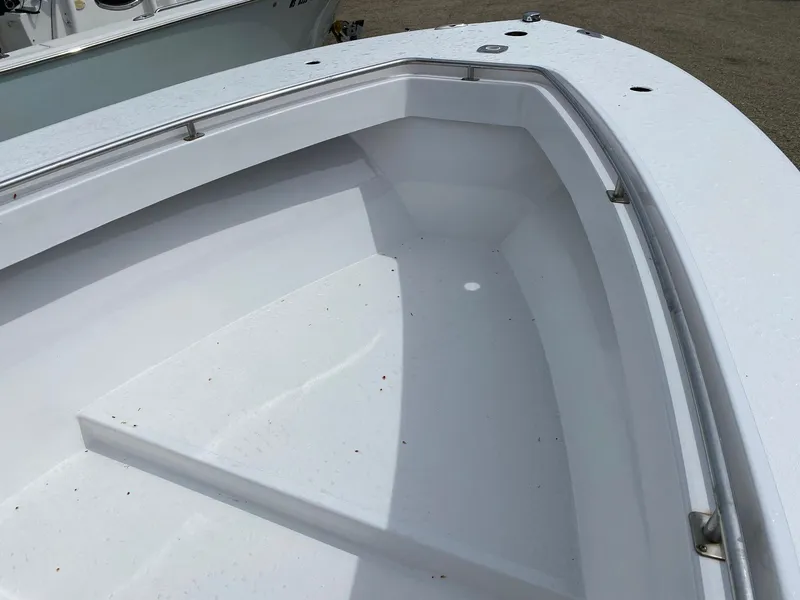 Slide: The Image of 1987 SeaCraft 23 CC boat interior, showcasing clean white deck and storage area. - 13