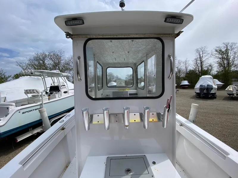 Slide: The Image of 1987 SeaCraft 23 CC boat with rod holders and cabin view. - 6
