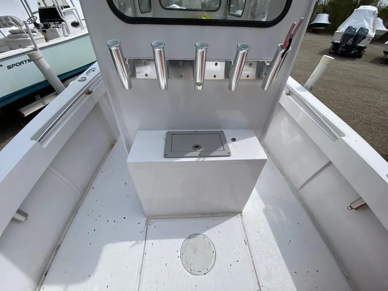 Slide: The Image of 1987 SeaCraft 23 CC boat interior with rod holders and storage compartment. - 7