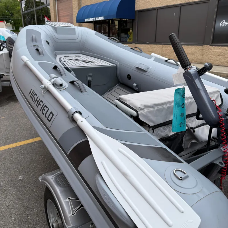 Slide: The Image of 2023 Highfield CL290 inflatable boat with oars, displayed outdoors. - 4