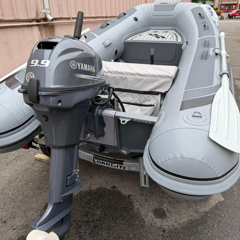 Slide: The Image of 2023 Highfield CL290 inflatable boat with Yamaha 9.9 motor, parked on a trailer. - 7