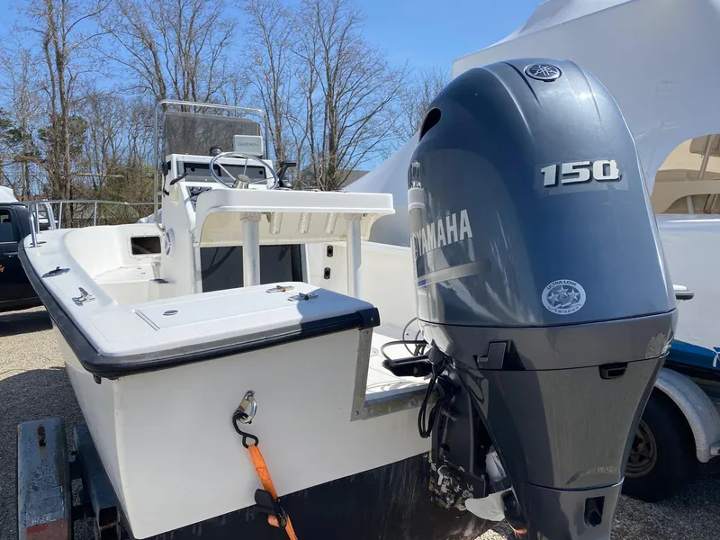 Slide: The Image of 1995 Sailfish 19 boat with Yamaha 150 outboard motor, parked on a trailer. - 12