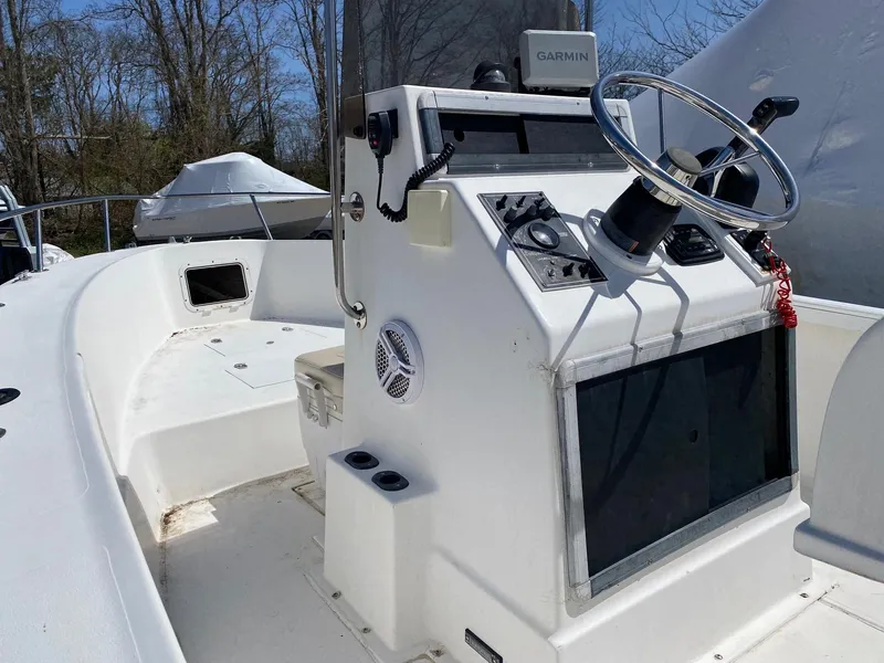 Slide: The Image of 1995 Sailfish 19 boat interior with steering wheel and Garmin navigation system. - 13