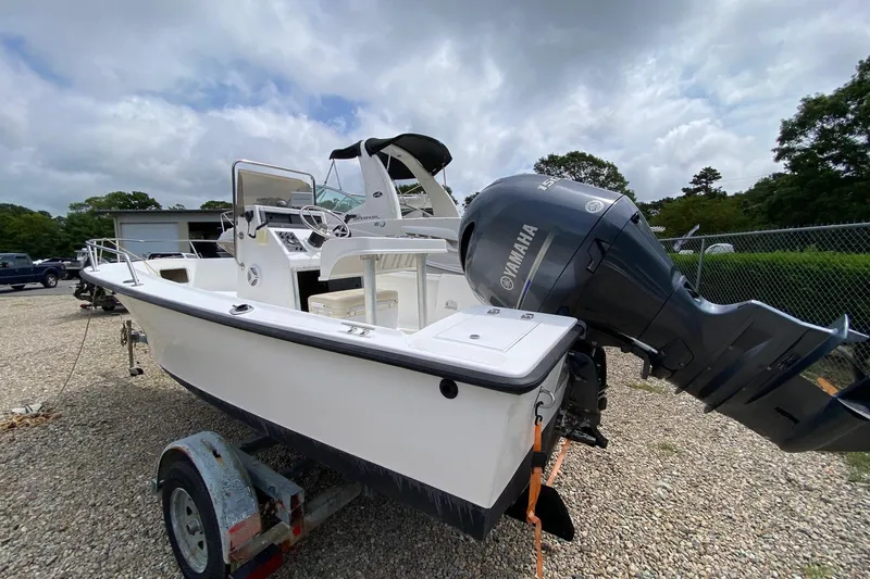 Slide: The Image of 1995 Sailfish 19 boat with Yamaha outboard motor on trailer, parked outdoors. - 4