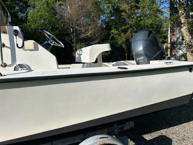 Slide: The Image of 1995 Sailfish 19 boat with 150 HP engine, parked outdoors. - 9
