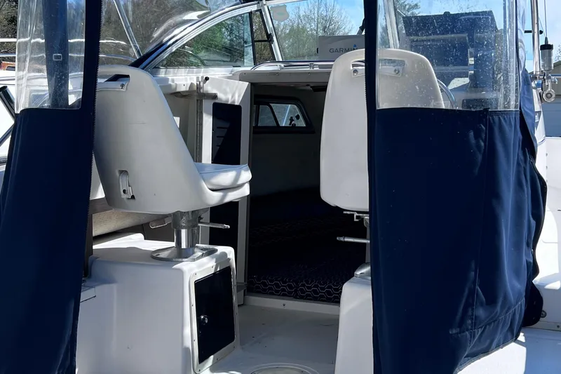 Slide: The Image of 1994 Grady-White 20 Adventure boat interior with blue curtains and white seats. - 5