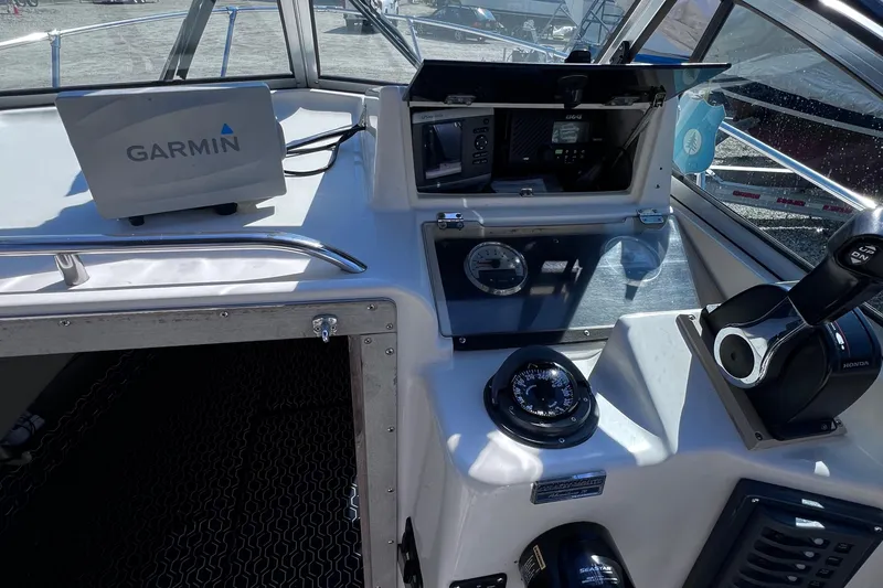 Slide: The Image of 1994 Grady-White 20 Adventure boat cockpit with Garmin navigation system and control panel. - 6